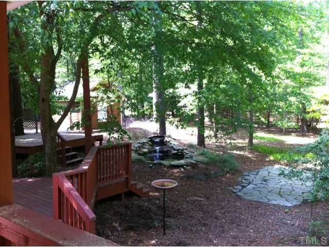 225 Carriage Trail Raleigh, NC 27614 - Photo 6 of 25 a view of a patio with table and chairs potted plants and large tree