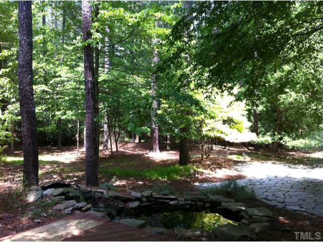 225 Carriage Trail Raleigh, NC 27614 - Photo 7 of 25 a view of a yard with plants and large trees
