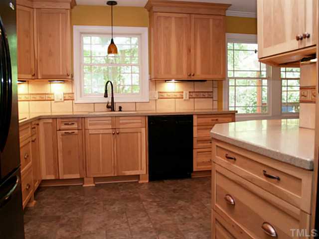 225 Carriage Trail Raleigh, NC 27614 - Photo 10 of 25 a kitchen with granite countertop a sink window and cabinets