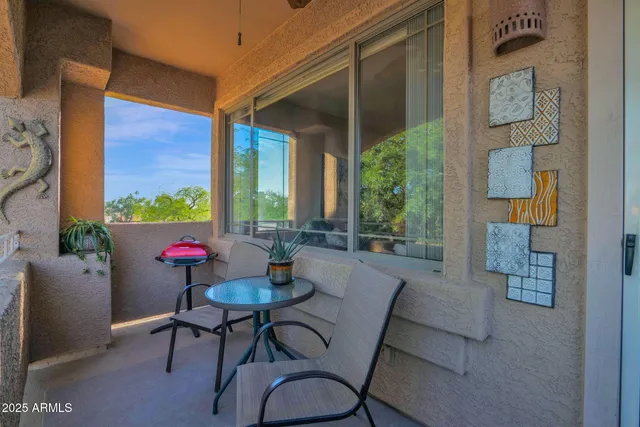 a dining room with wooden floor a chandelier a wooden table and chairs