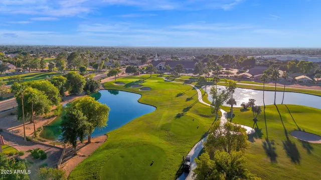 an aerial view of a swimming pool with outdoor seating and city view