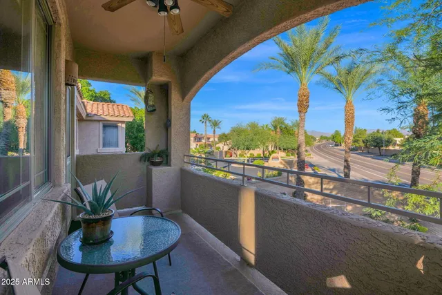 a living room with furniture and large windows