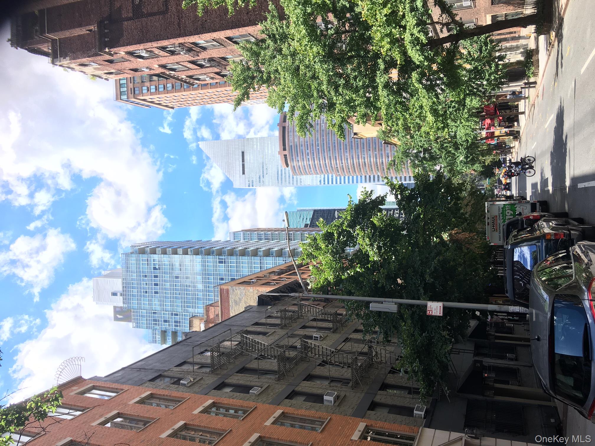 334 East 53rd Street, Unit 3A Manhattan, NY 10022 - Photo 1 of 9 a city street lined with buildings and trees