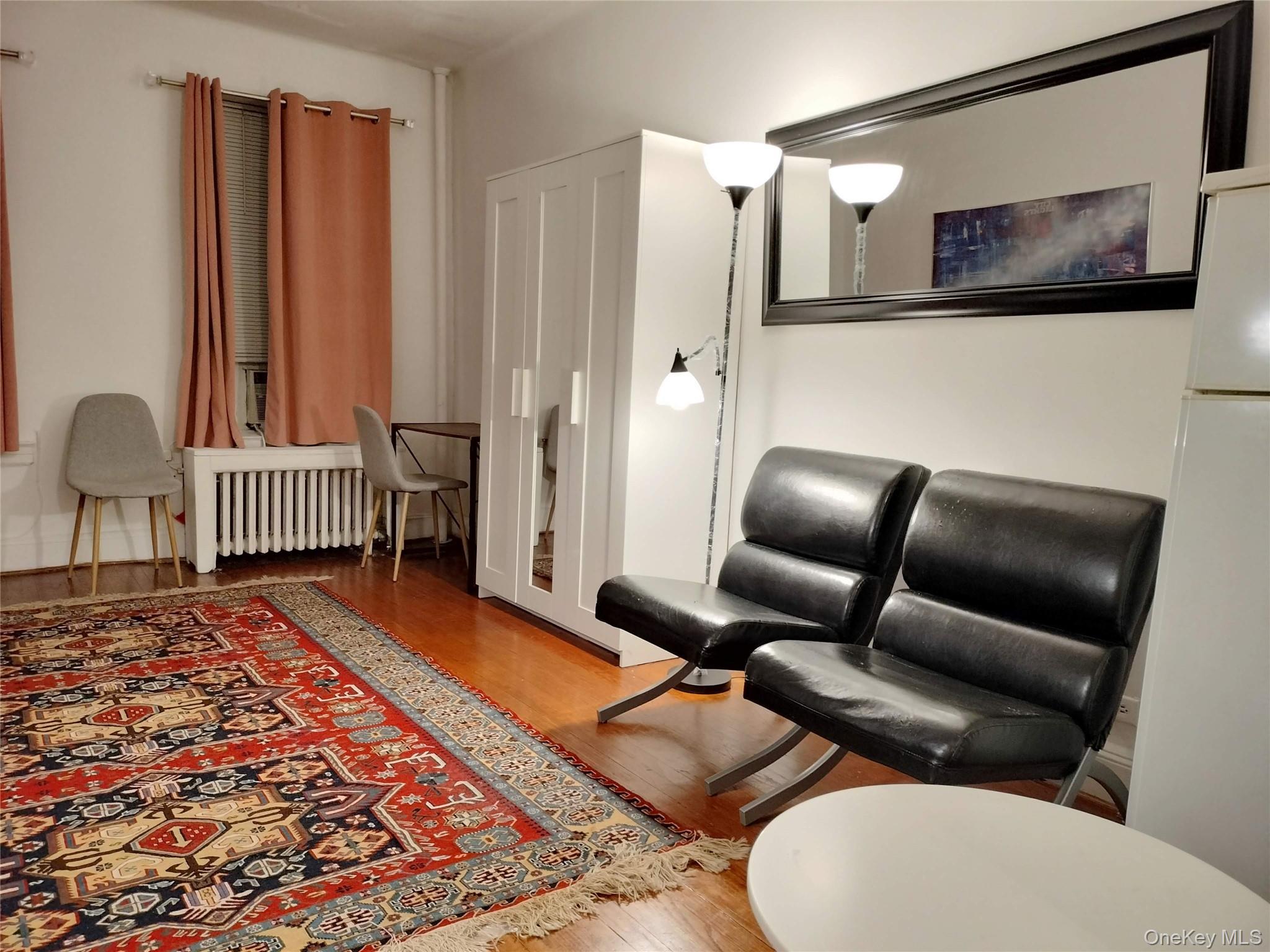 334 East 53rd Street, Unit 3A Manhattan, NY 10022 - Photo 3 of 9 a living room with furniture and a rug