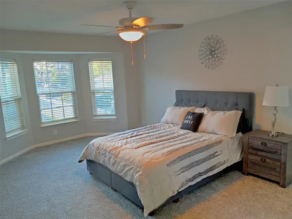 a living room with a flat screen tv furniture and a lamp