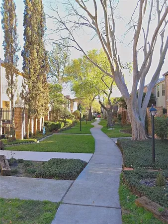 a view of empty room with wooden floor and fireplace