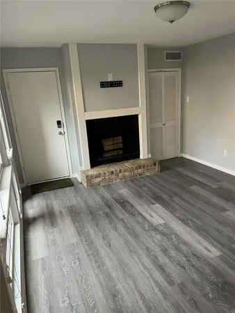 a view of a small space with wooden floor and closet