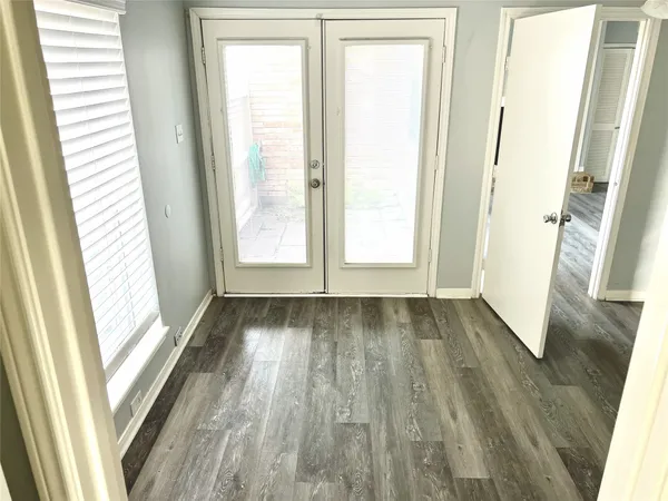 a kitchen with a stove cabinets and wooden floor