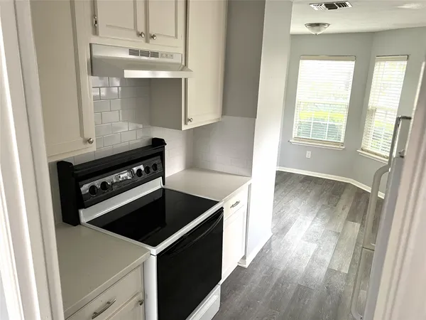 a kitchen with a stove and a refrigerator
