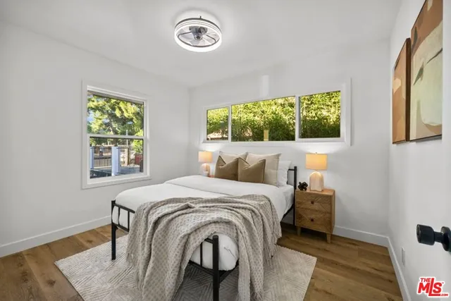 a bed sitting in a bedroom next to a window