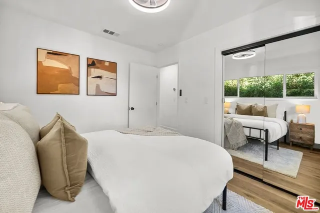 a bedroom with furniture and a large window