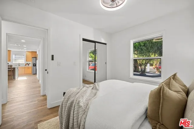 a bedroom with a bed and a window