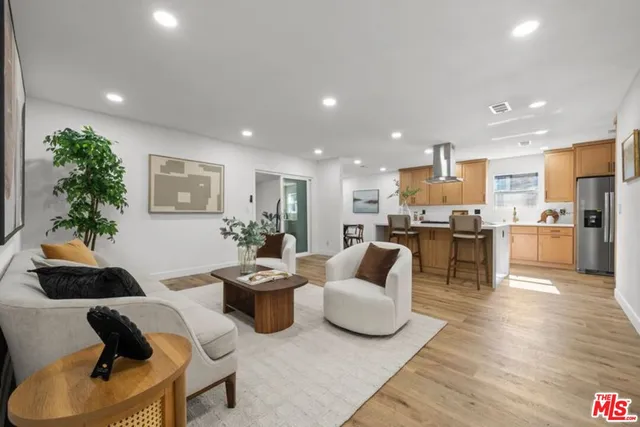 a living room with furniture and kitchen view