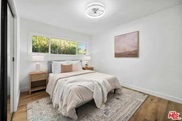 a bedroom with a bed and a window