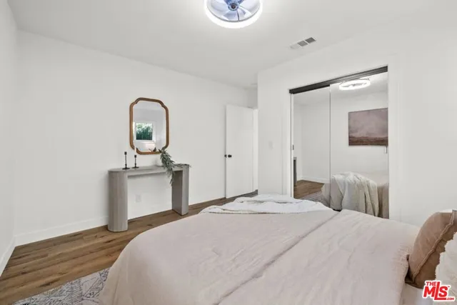 a bedroom with a bed and a dresser