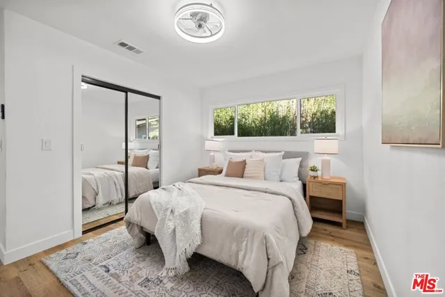 a bedroom with bed and a window