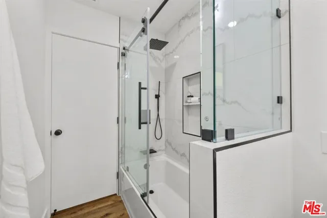 a bathroom with a shower and a sink