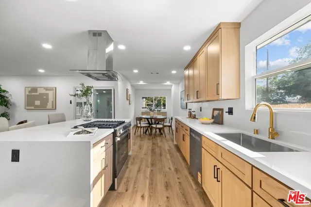 a kitchen with a sink stove and cabinets