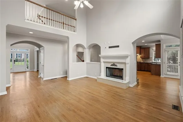 a view of a livingroom with wooden floor and a fireplace