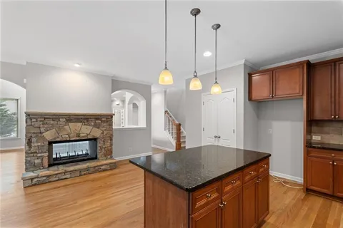 a kitchen with cabinets and wooden floor