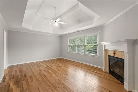 an empty room with windows and fireplace