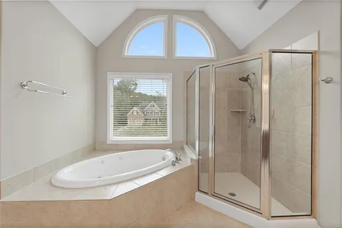 a bathroom with a bathtub and a shower