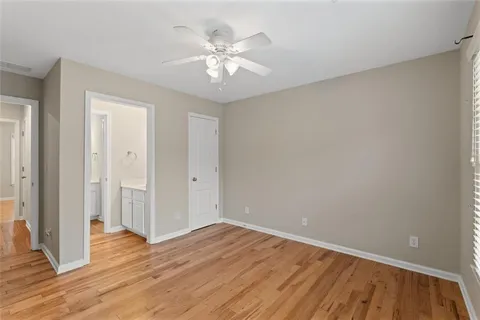 a view of a room with wooden floor and ceiling fan