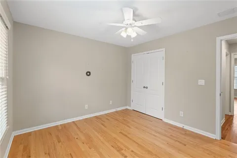 a view of an empty room with wooden floor