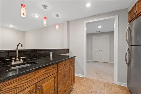 a kitchen with stainless steel appliances granite countertop a sink and a refrigerator