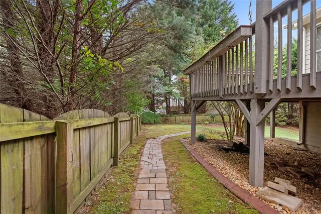 a view of a house with backyard and a tree