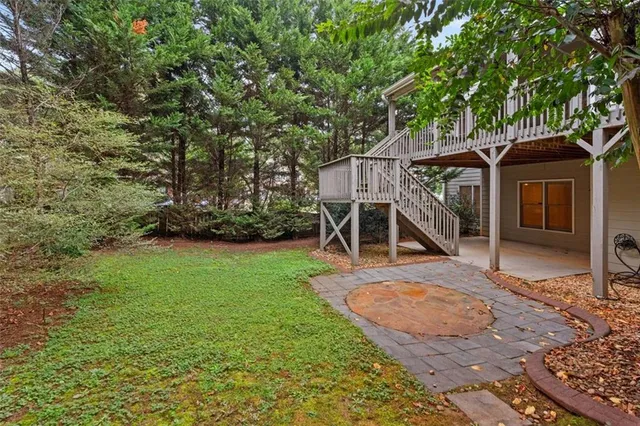 a view of a yard with plants and trees