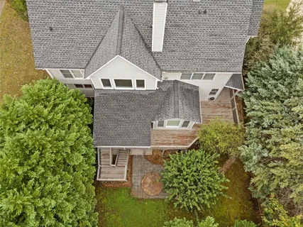 a aerial view of a house with a yard and potted plants