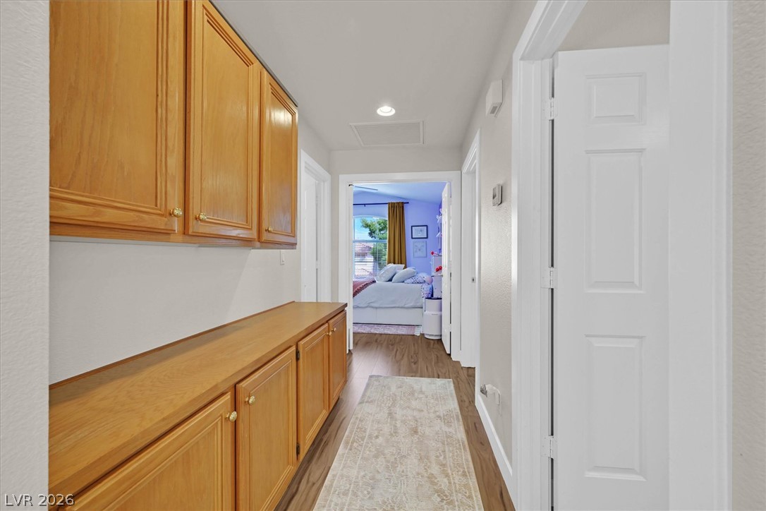 1259 Moon Vision Street Henderson, NV 89052 - Photo 27 of 53 Streamlined hallway storage with rich wood cabinetry provides practical organization.