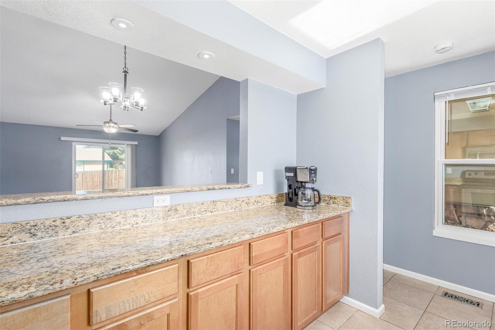5105 Chandler Way Denver, CO 80239 - Photo 11 of 32 a bathroom with a granite countertop sink and a mirror