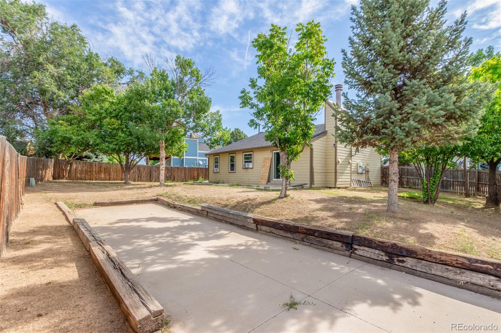 5105 Chandler Way Denver, CO 80239 - Photo 29 of 32 a view of a house with tree s