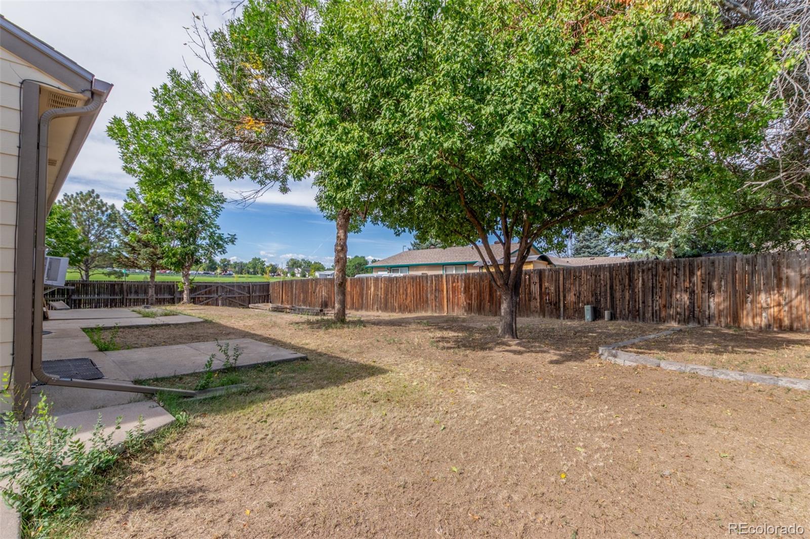 5105 Chandler Way Denver, CO 80239 - Photo 31 of 32 a view of a yard with wooden fence