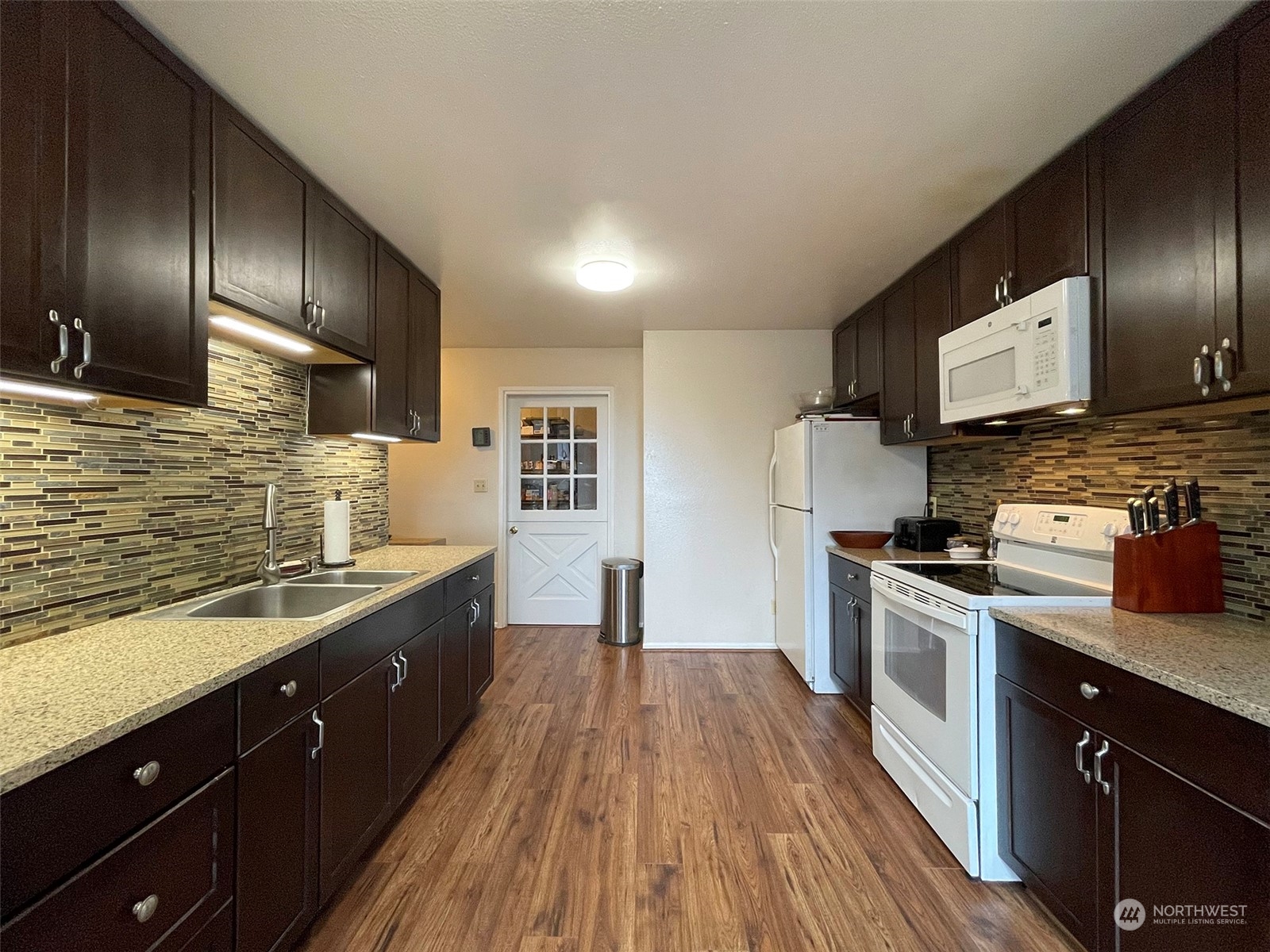 42 Sekiu Airport Road Sekiu, WA 98381 - Photo 10 of 27 a kitchen with stainless steel appliances granite countertop a stove a sink and a refrigerator