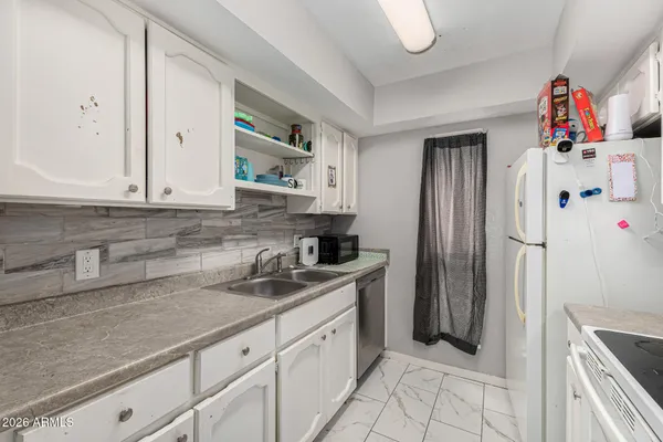 a kitchen that has a sink and a stove
