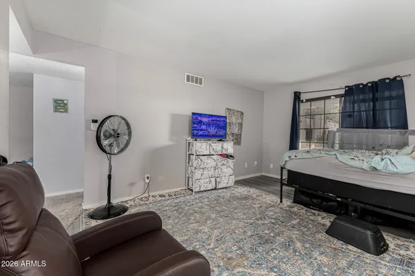 a view of a bedroom with furniture and a window