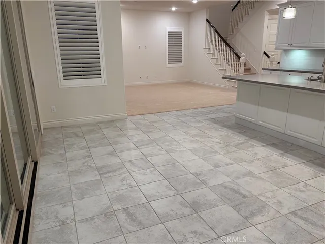 a kitchen with cabinets and steel appliances