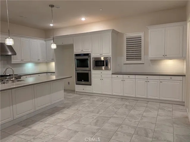a stove top oven sitting inside of a kitchen