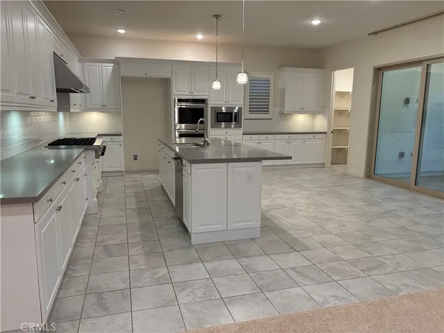 a kitchen with granite countertop a stove a sink and a granite counter tops