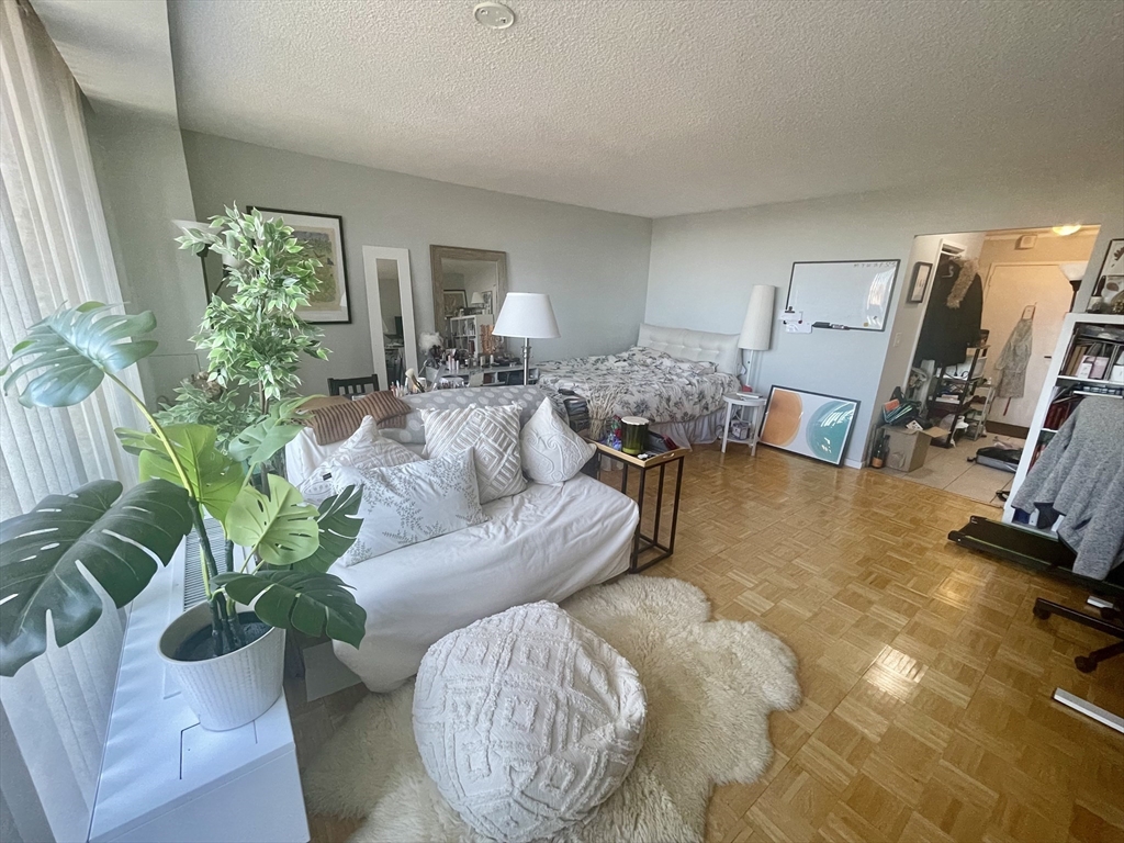 44 Washington Street, Unit 1009 Brookline, MA 02445 - Photo 2 of 12 a living room with furniture and a large window
