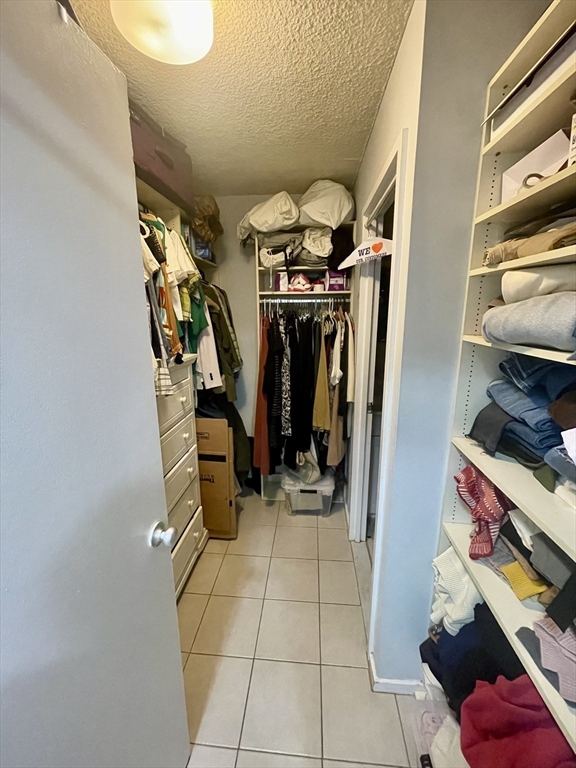 44 Washington Street, Unit 1009 Brookline, MA 02445 - Photo 4 of 12 a view of walk in closet with clothes and shoes