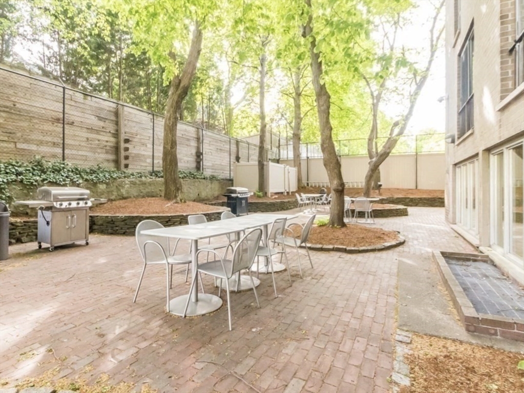 44 Washington Street, Unit 1009 Brookline, MA 02445 - Photo 10 of 12 a view of a patio with swimming pool and sitting space