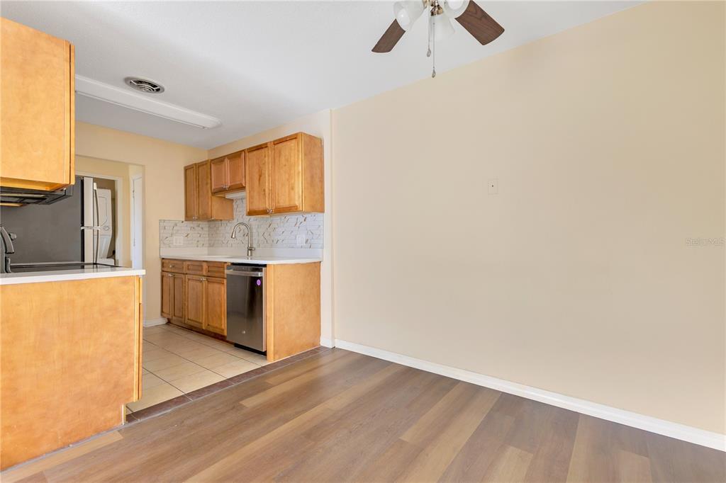 1695 Lee Road, Unit E103 Winter Park, FL 32789 - Photo 16 of 20 a kitchen with granite countertop a sink stainless steel appliances and cabinets
