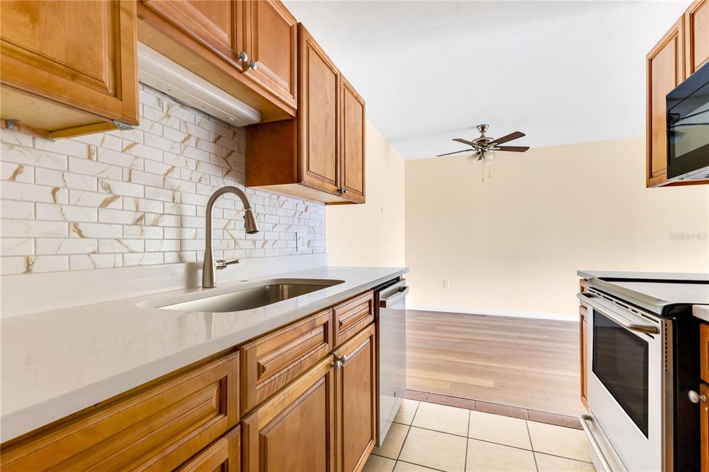 1695 Lee Road, Unit E103 Winter Park, FL 32789 - Photo 18 of 20 a kitchen with a sink and cabinets