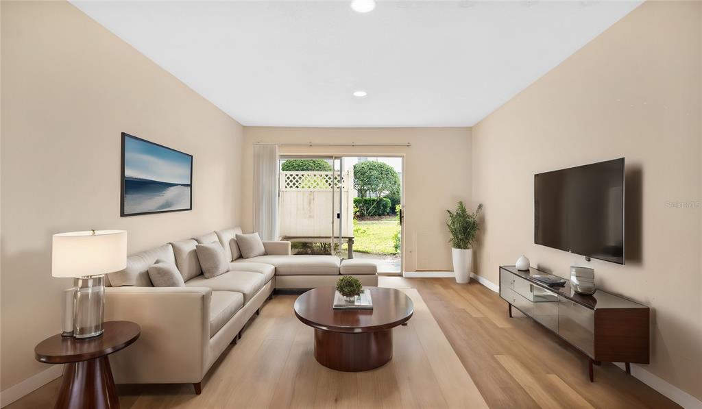 1695 Lee Road, Unit E103 Winter Park, FL 32789 - Photo 19 of 20 a living room with furniture and a flat screen tv