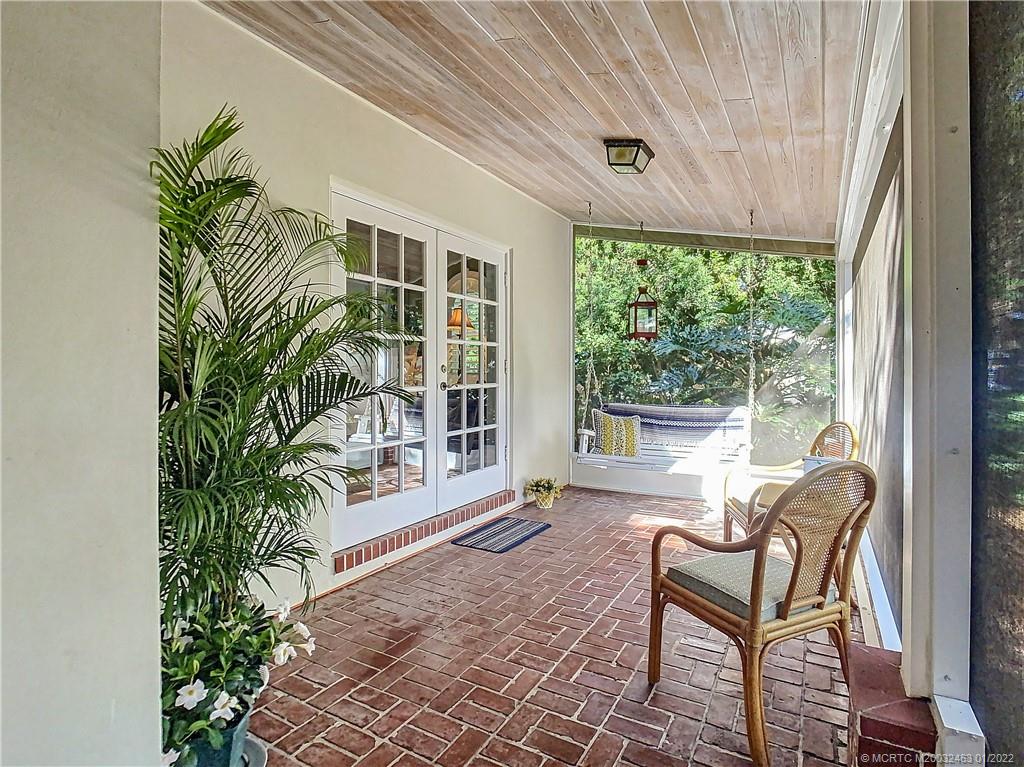 9 Ridgeview Road North Stuart, FL 34996 - Photo 17 of 20 a porch with a bench and chairs