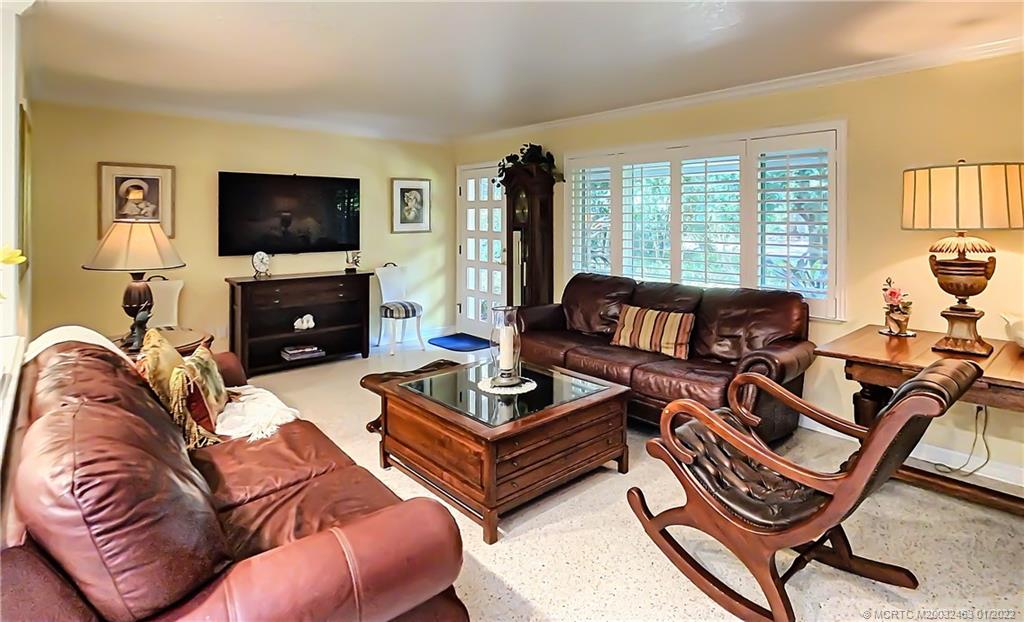 9 Ridgeview Road North Stuart, FL 34996 - Photo 4 of 20 a living room with furniture a flat screen tv and a large window